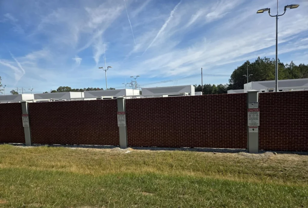 Detail of a precast concrete panel-and-column wall with a red brick finish and white columns — representative of the engineered system Permacast installs around Newnan residential, medical, and commercial sites